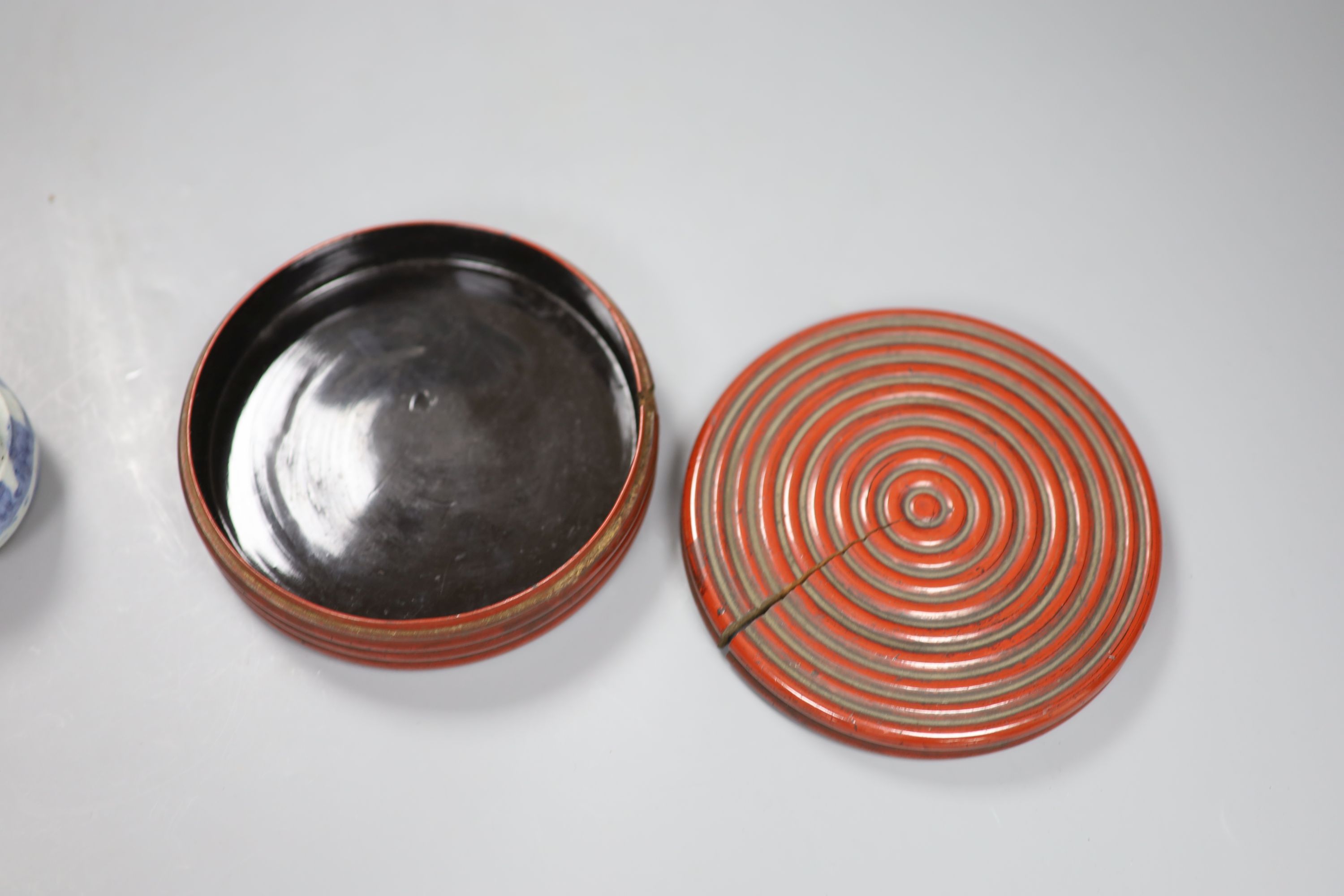 A Chinese red lacquer lidded box, diameter 12.5cm, and a blue and white water dropper